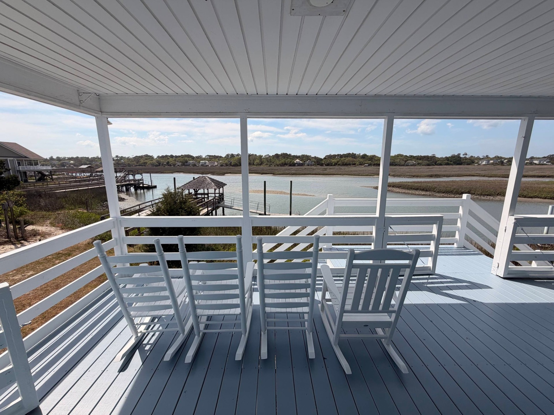Marsh-front porch repaint with soft blue decking and white rails