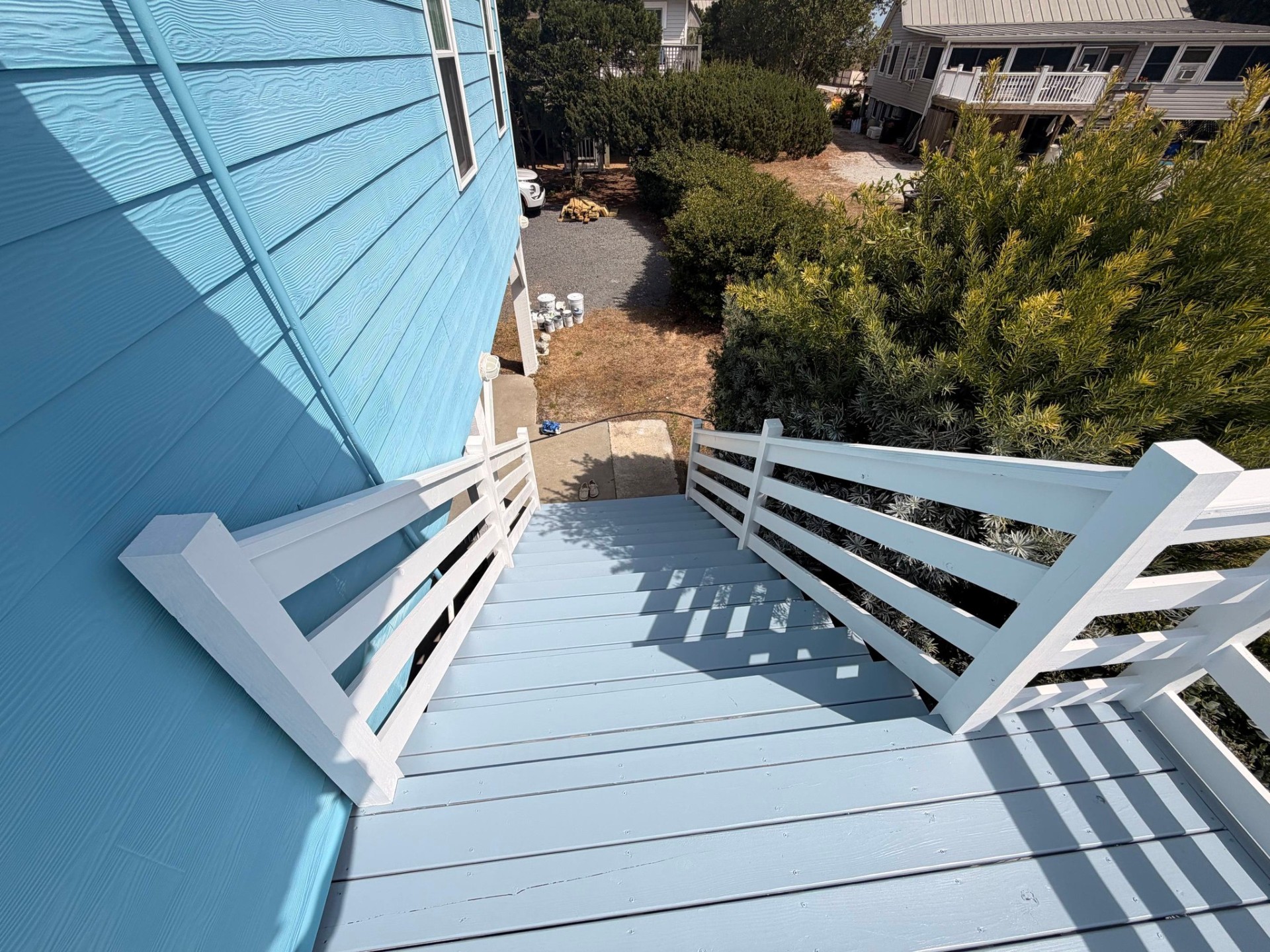 Stairwell and exterior deck painted in coastal blue and white