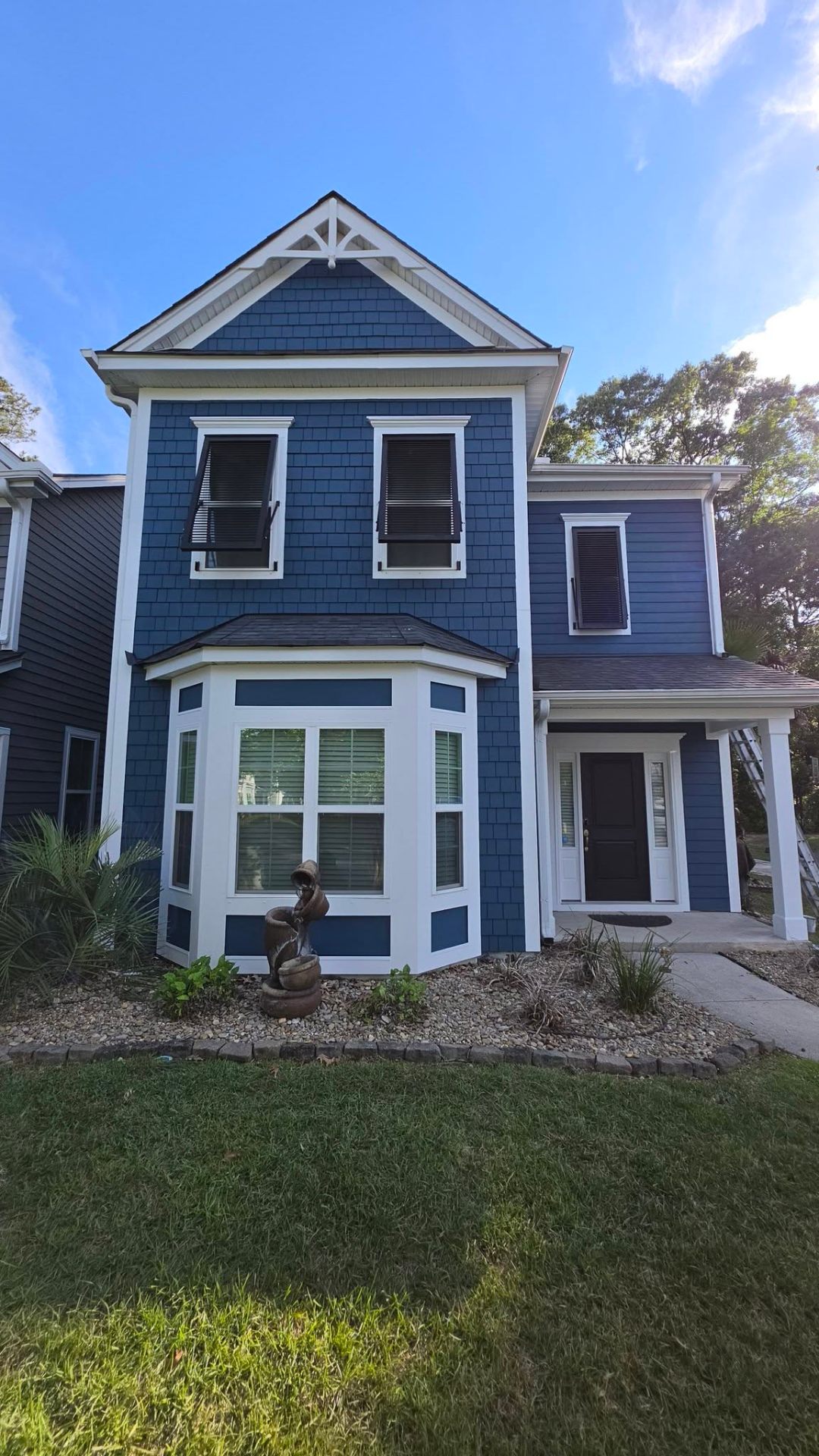 Navy blue exterior repaint with crisp white trim — Lowcountry home