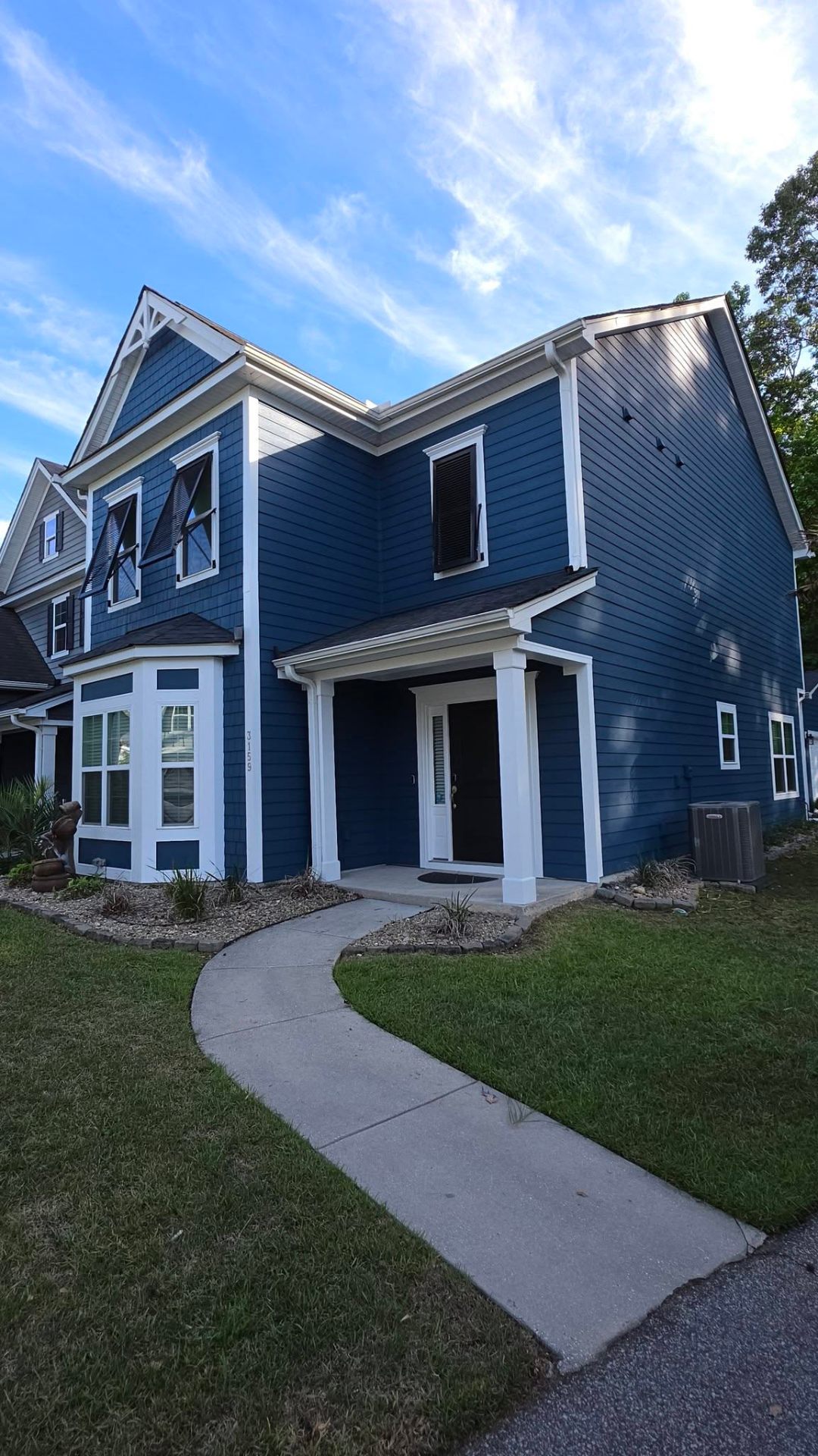 Front elevation of repainted blue Lowcountry farmhouse