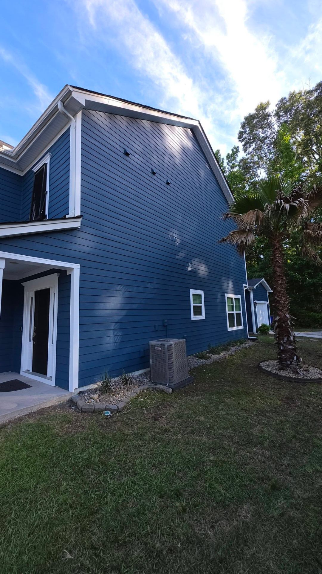 Side elevation showing deep blue HardiePlank siding installation
