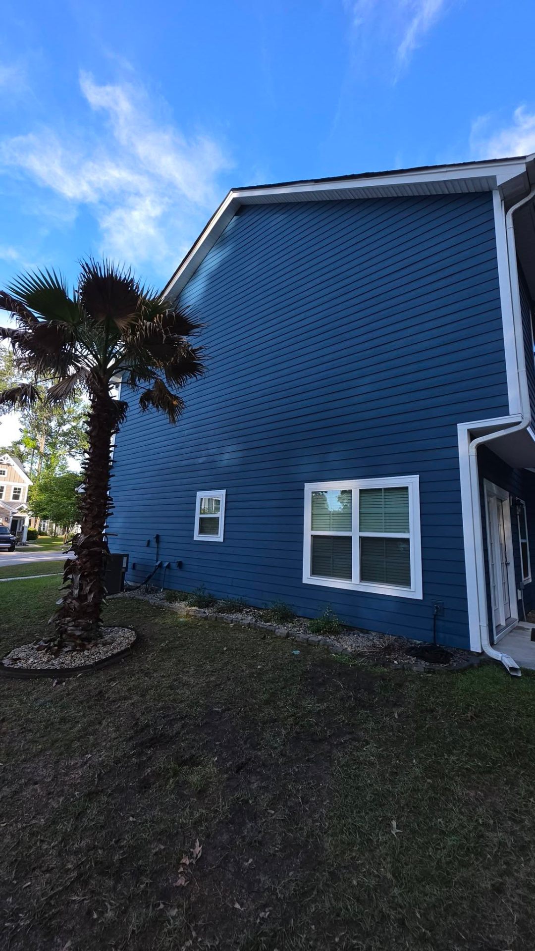 Full gable view of navy blue exterior paint job with white fascia
