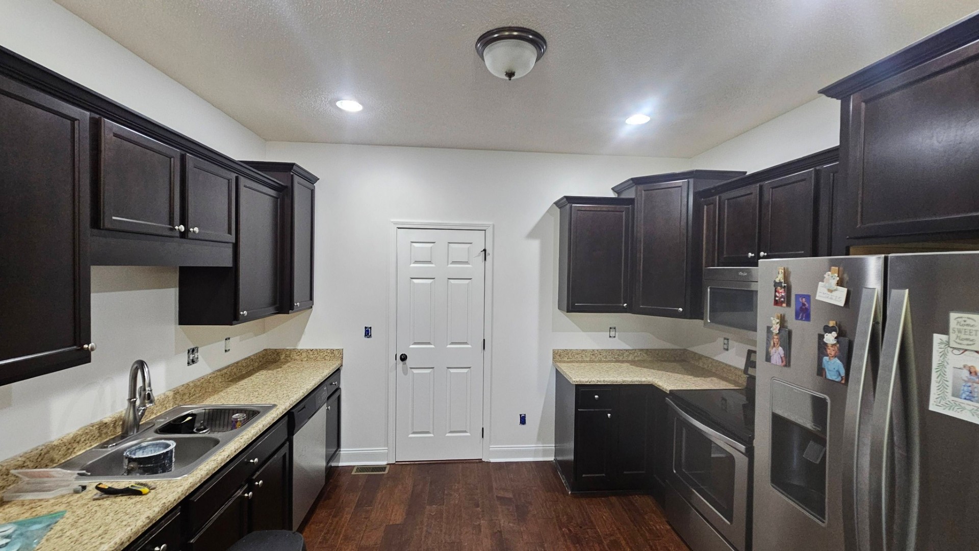 Kitchen after cabinet refinishing in dark espresso stain