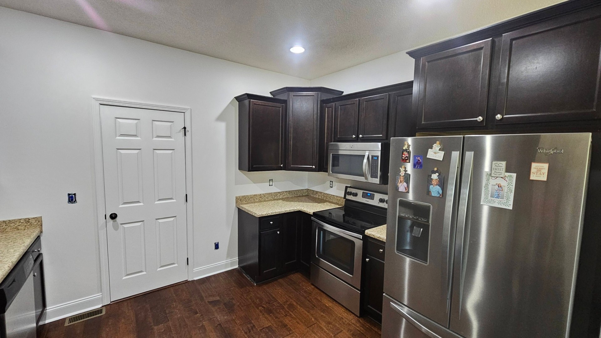 Refinished espresso kitchen cabinets with fresh white walls
